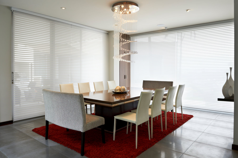 dining room table surrounded by windows with window blinds