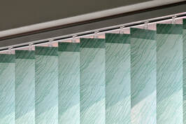 close-up of green vertical blinds 